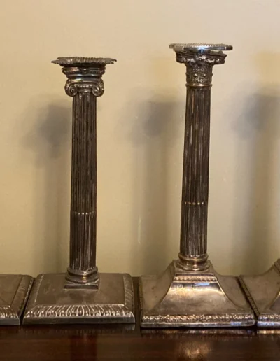 Silver corinthian candlesticks before